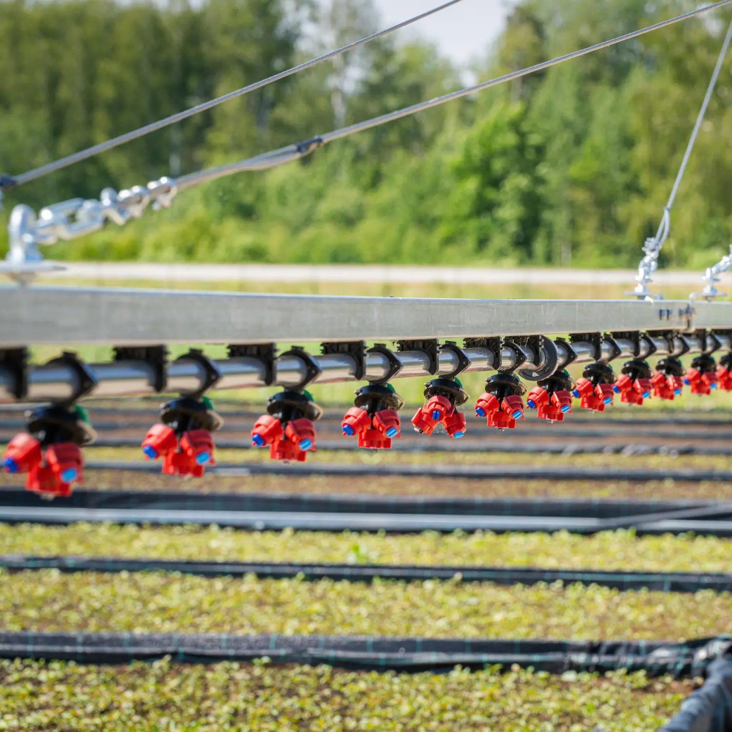 Close-up of irrigation boom sprayer nozzles distributing water precisely